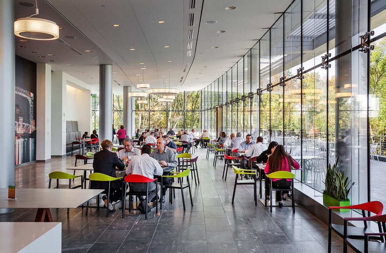 Eaton: A long cafeteria with colorful chairs along a full-height glass wall