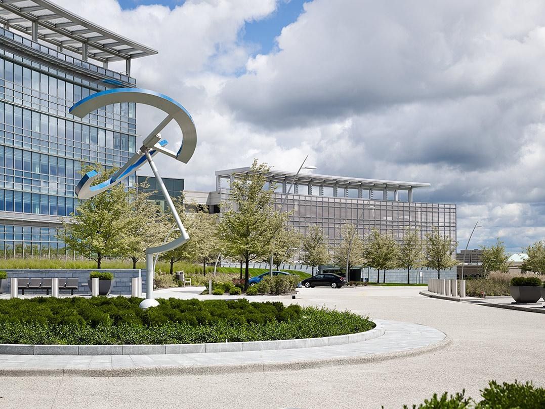 Eaton: A stainless steel sculpture on a round lawn in front of the entrance