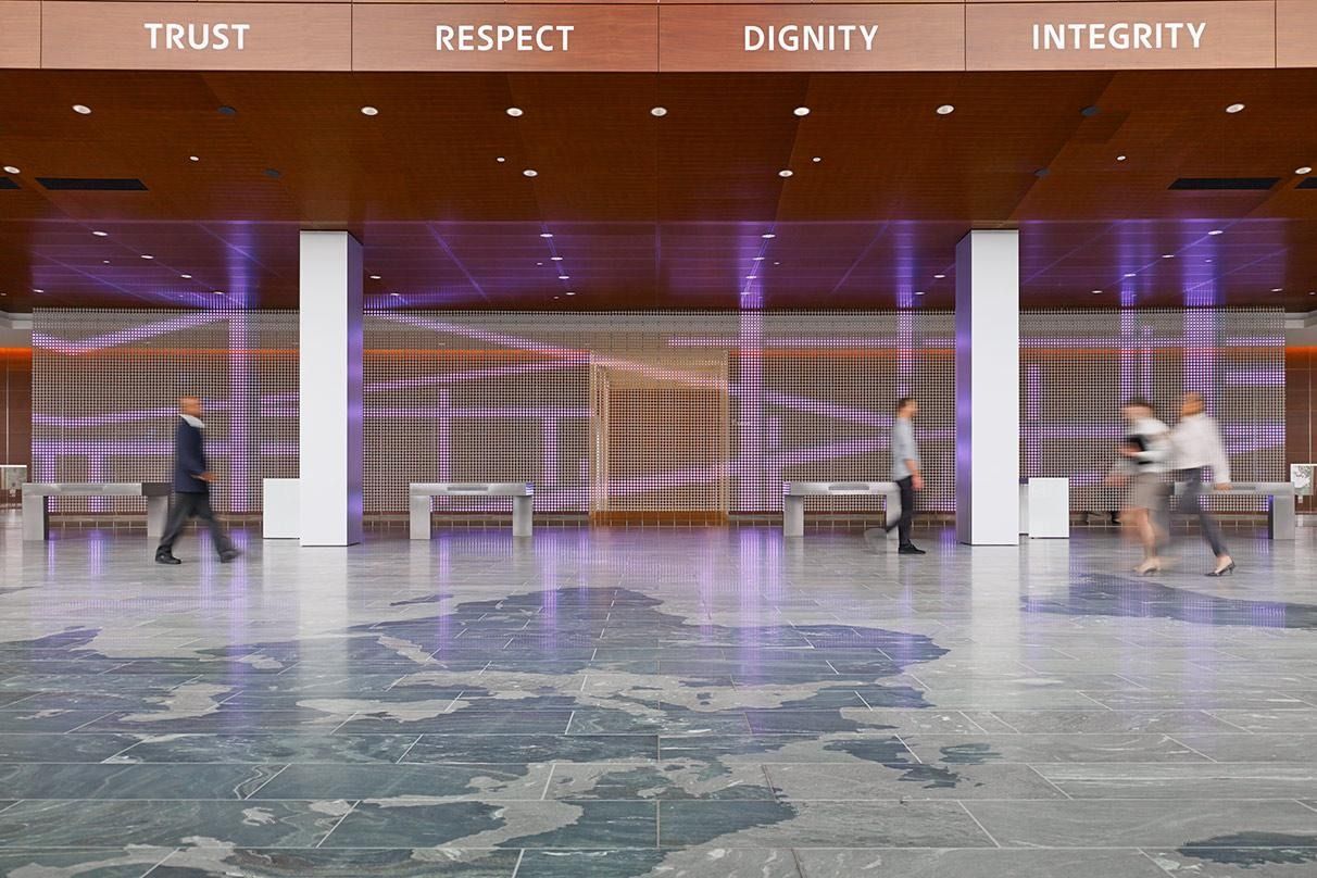 Eaton: A wide stone-floored hall with the words Respect, Dignity and Integrity on the wall