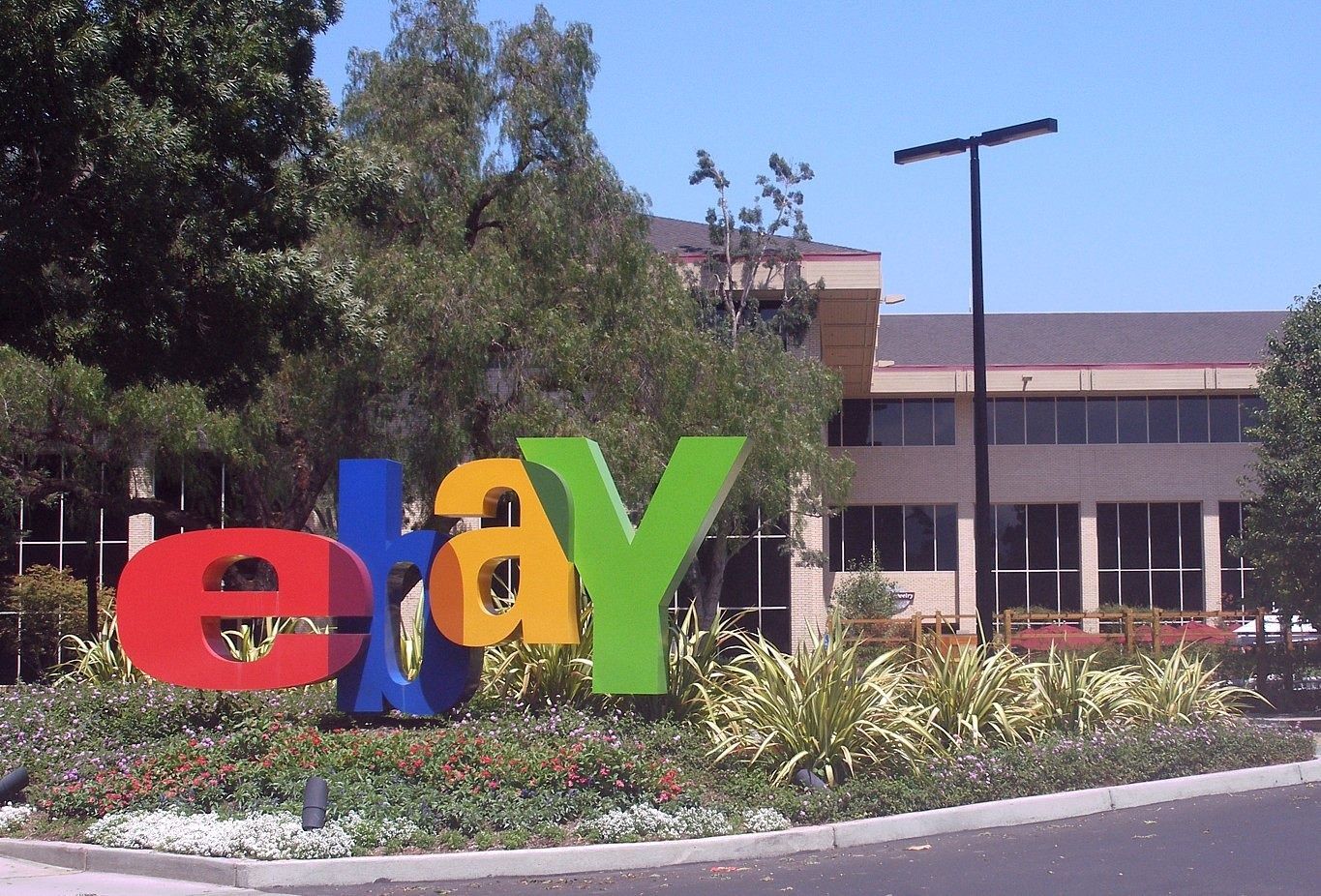 eBay: eBay letters in front of a campus building among trees