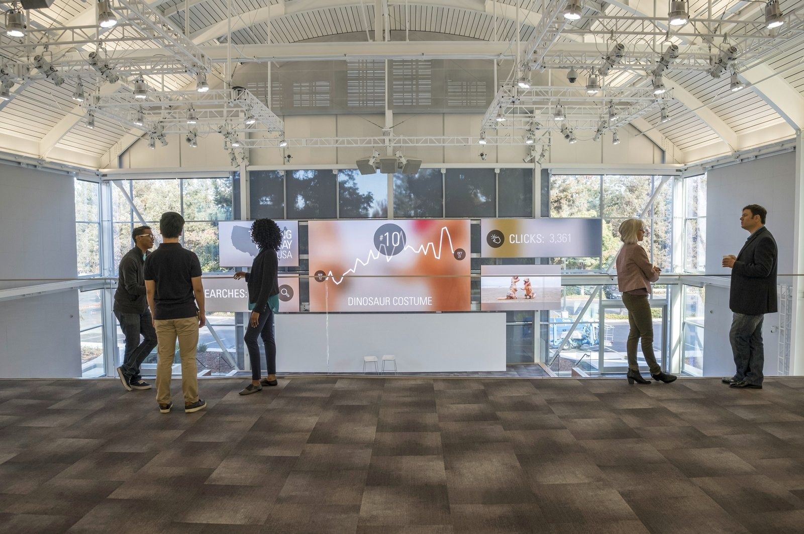 eBay: Glass-roofed showroom with a long video wall