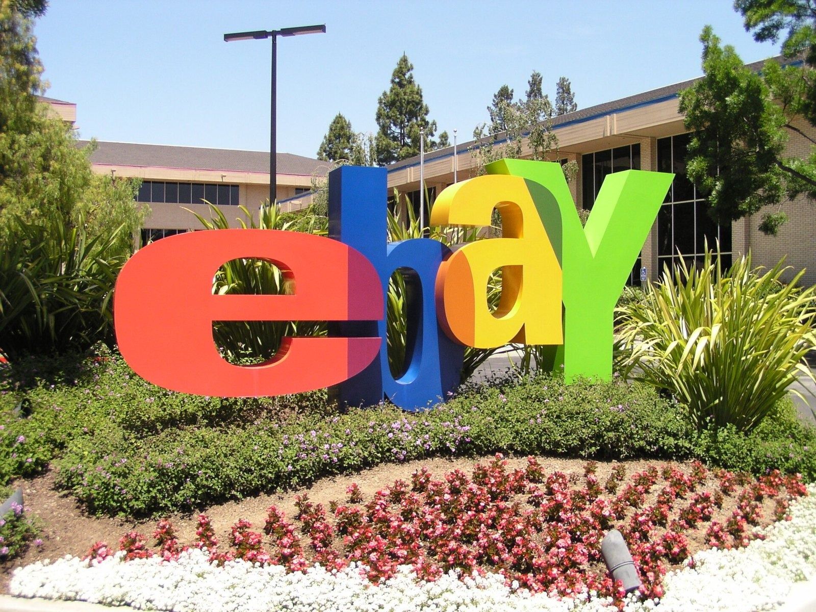 eBay: Large colourful eBay letters in a flower bed on campus