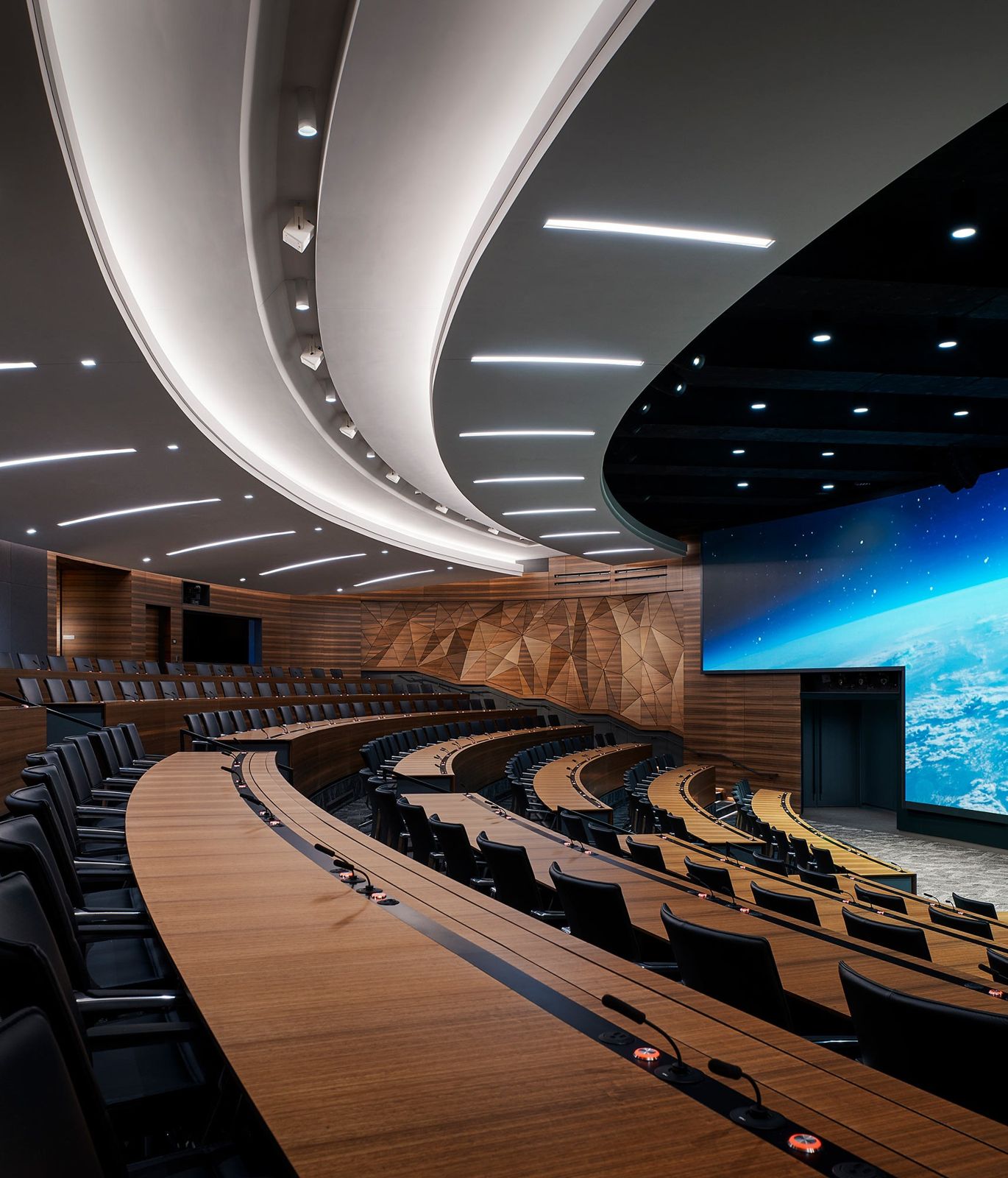 Edwards Lifesciences: Curved rows of the auditorium seen from the side under a sweeping white ceiling