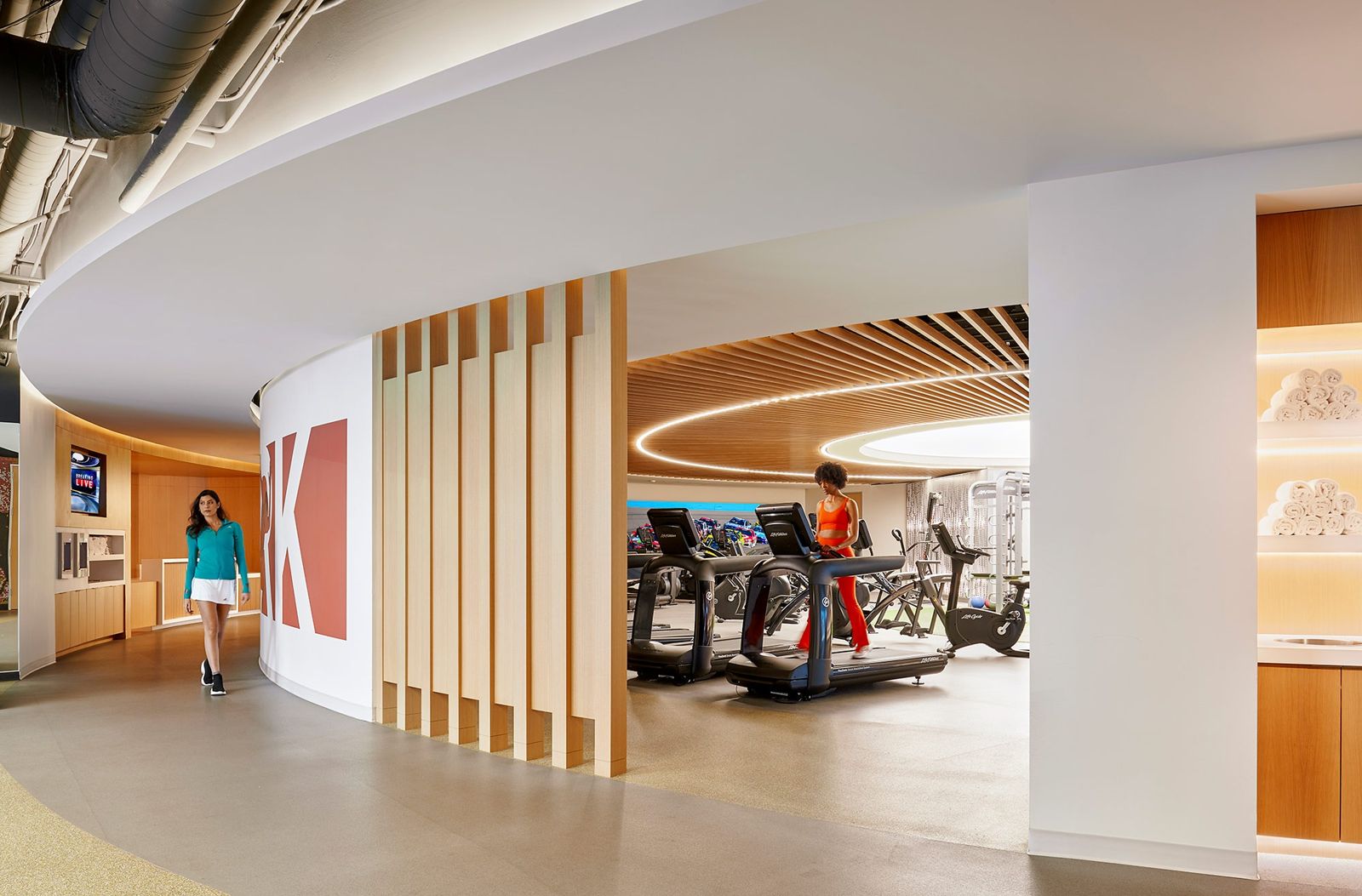 Edwards Lifesciences: Treadmills inside a curved, timber-slatted gym space