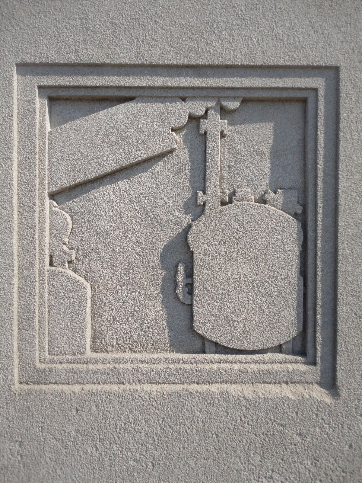 Eli Lilly and Company: A carved stone relief of lab equipment