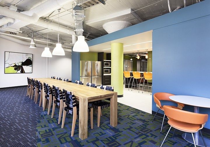 Eli Lilly and Company: A kitchen and long communal table under pendant lights