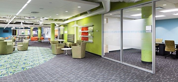 Eli Lilly and Company: A lounge with green walls and glass meeting rooms
