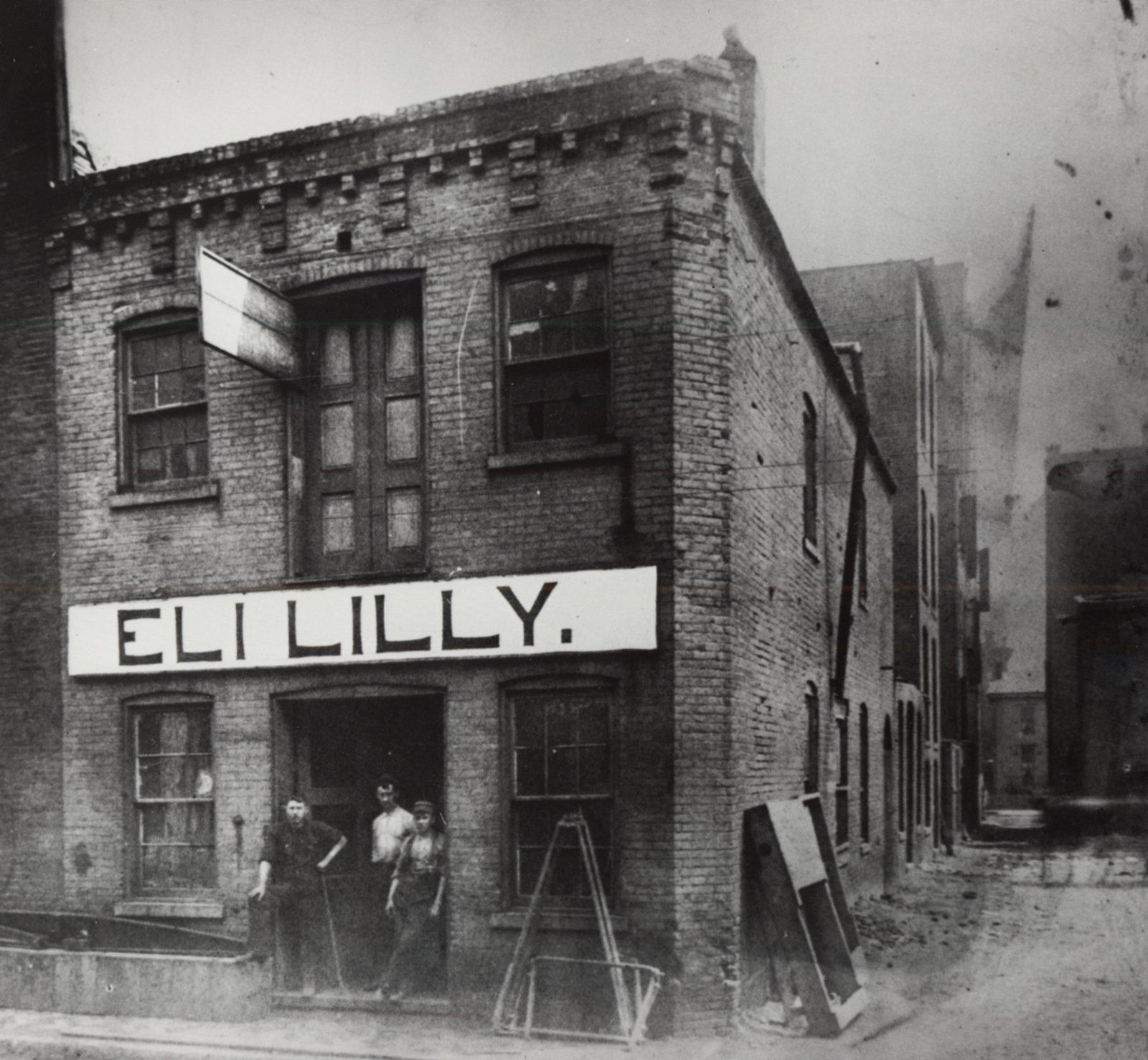 A small brick building with an Eli Lilly sign