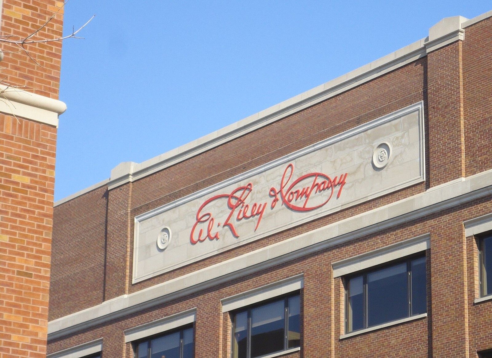 Eli Lilly and Company: The script Lilly signature on a brick facade