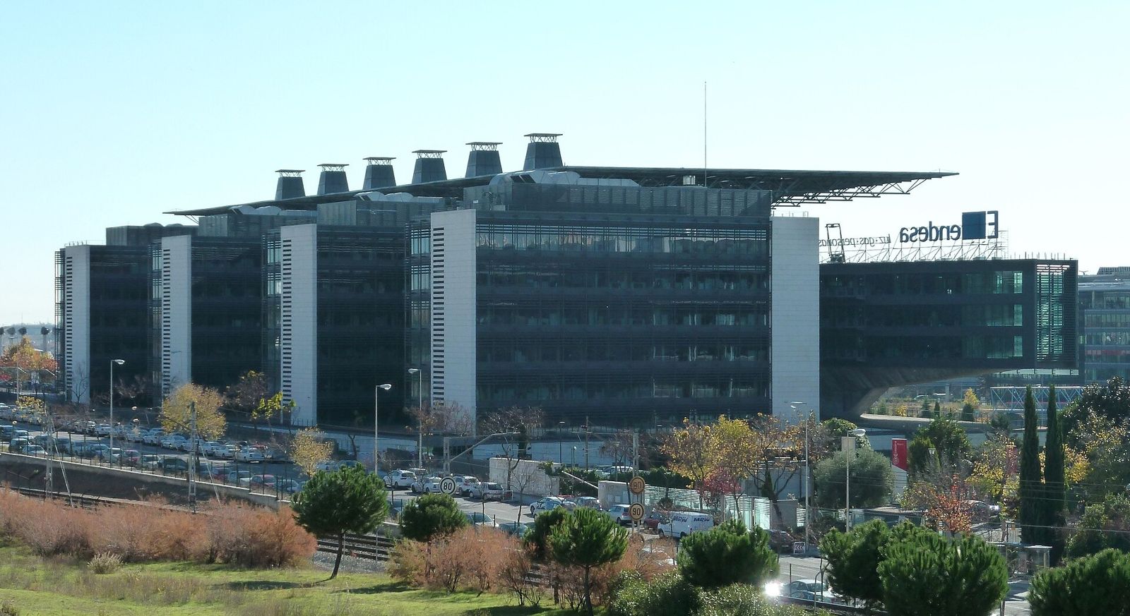 Endesa: A dark glass office block with stepped wings in late autumn light