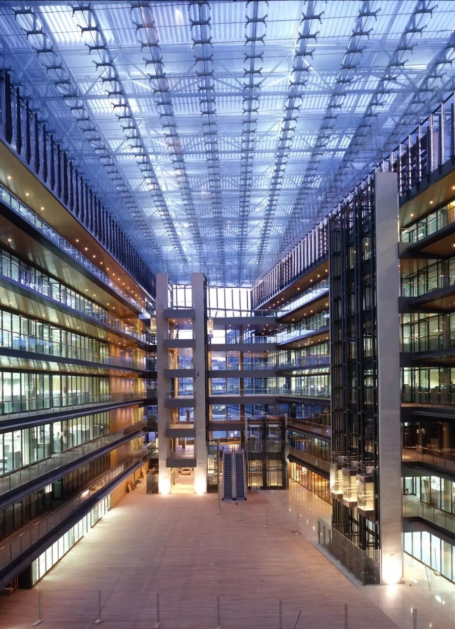 Endesa: A tall glass-roofed atrium lined with office floors and lit walkways