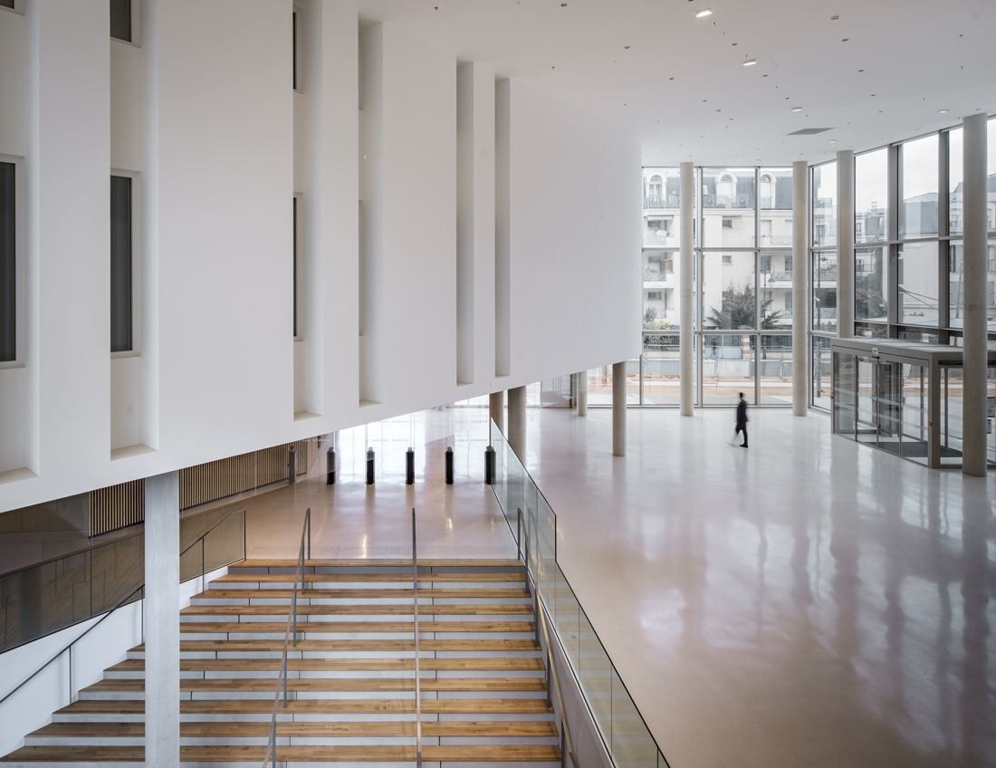 ENGIE: Large white double-height space with a wide stair and full-height glazing