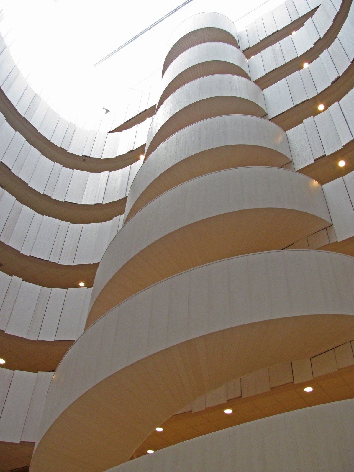 Ericsson: Curving white balustrades rising in a spiral atrium