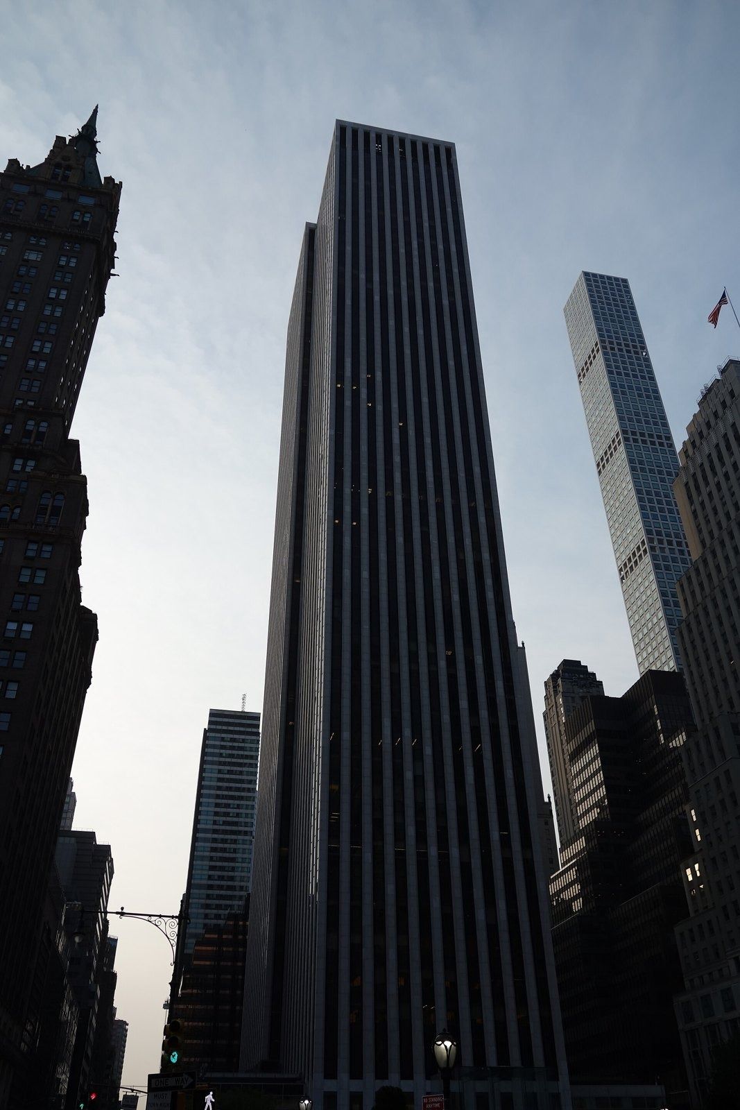 The Estée Lauder Companies: Dark marble-and-glass tower seen from below against a pale sky