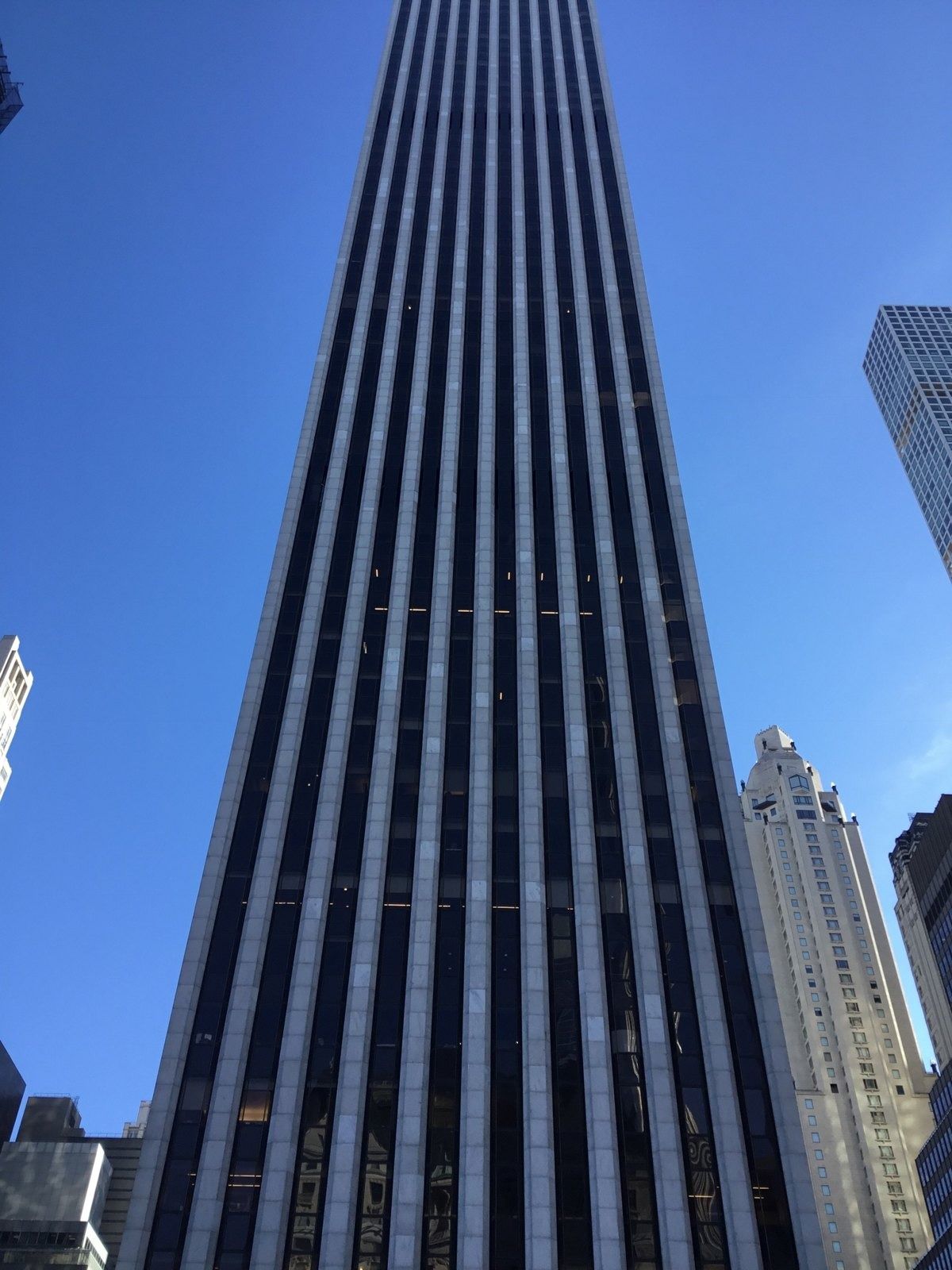 The Estée Lauder Companies: Front of a striped skyscraper seen head-on from street level