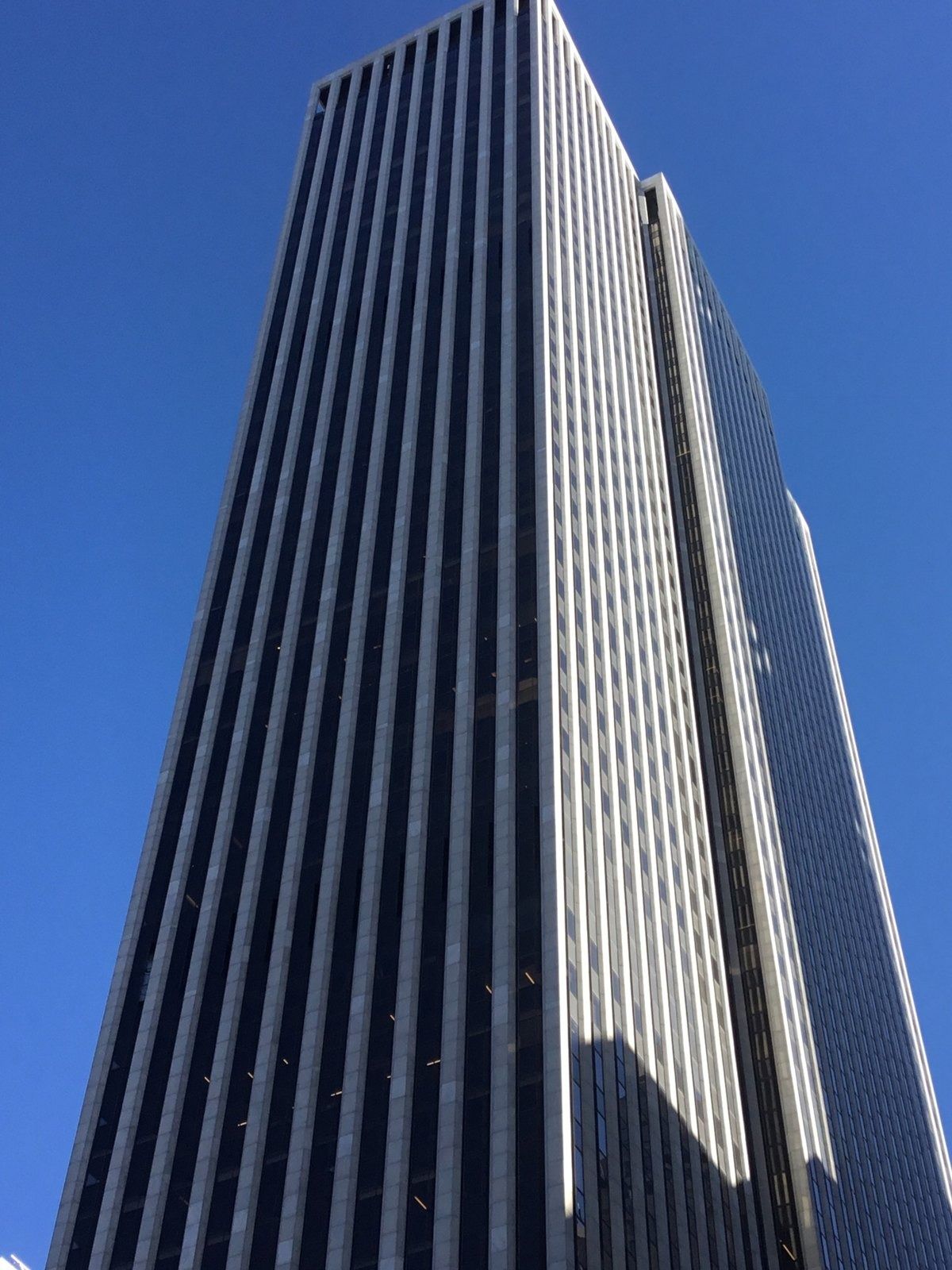 The Estée Lauder Companies: Striped skyscraper rising into a deep blue sky