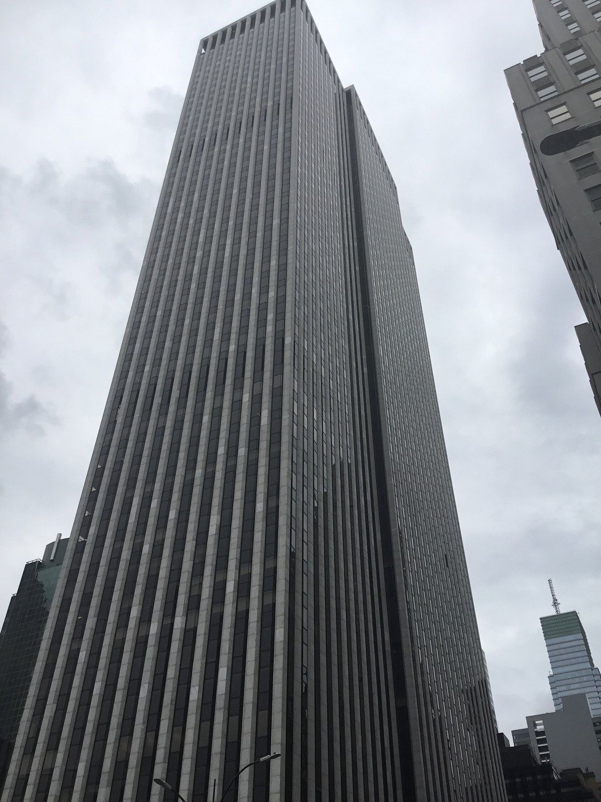 The Estée Lauder Companies: Striped skyscraper seen from a low corner angle under cloudy sky