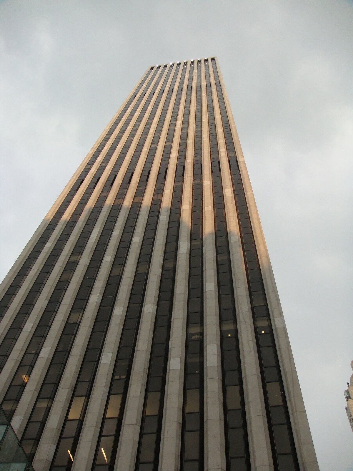 The Estée Lauder Companies: Tall tower with vertical stripes lit by warm evening sun