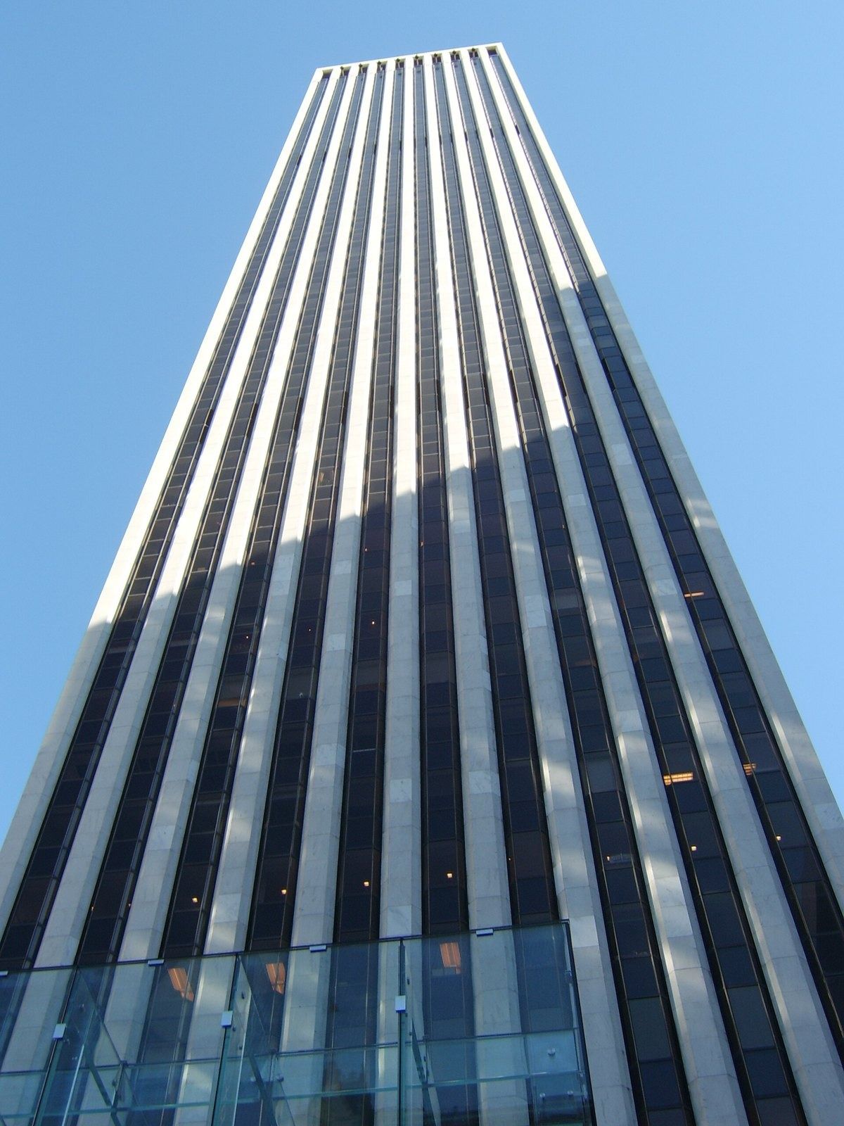 The Estée Lauder Companies: Upward view of a striped tower with a glass structure at its base