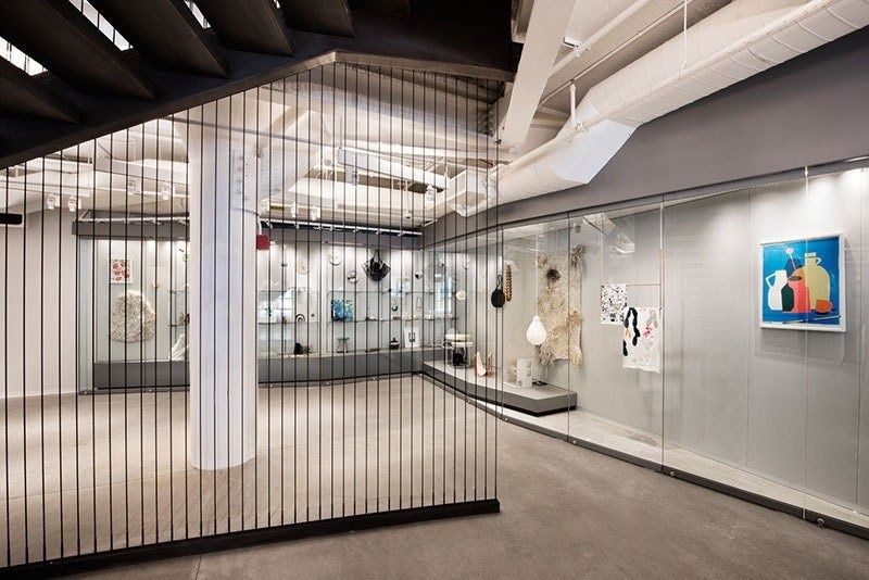 Etsy: Gallery cases behind a screen of vertical bars