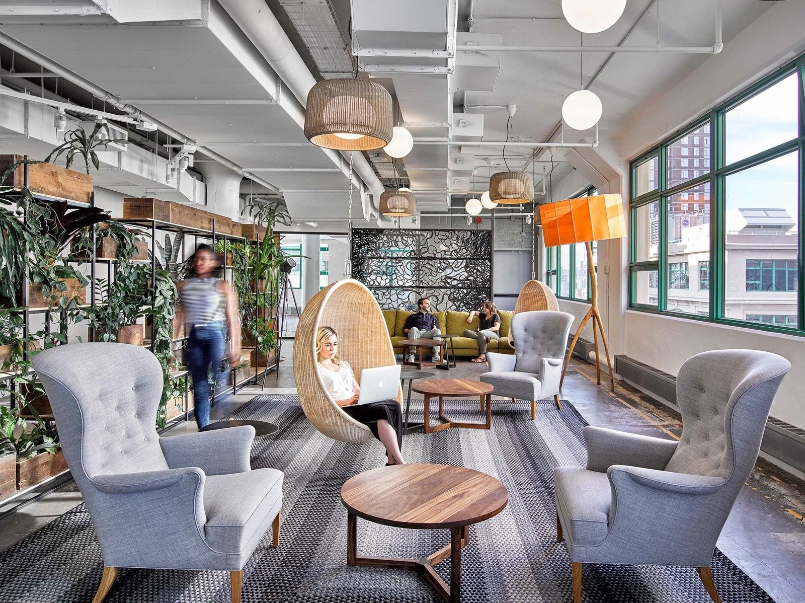 Etsy: Lounge with plants, armchairs and a hanging egg chair beside steel windows
