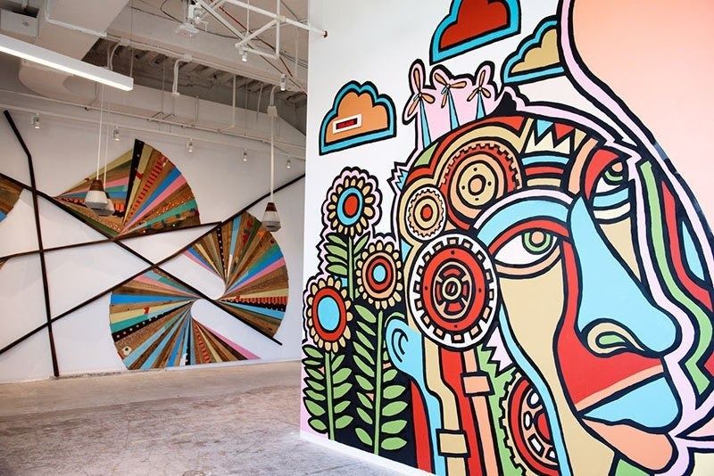 Etsy: Painted mural next to a geometric art installation made from old desks