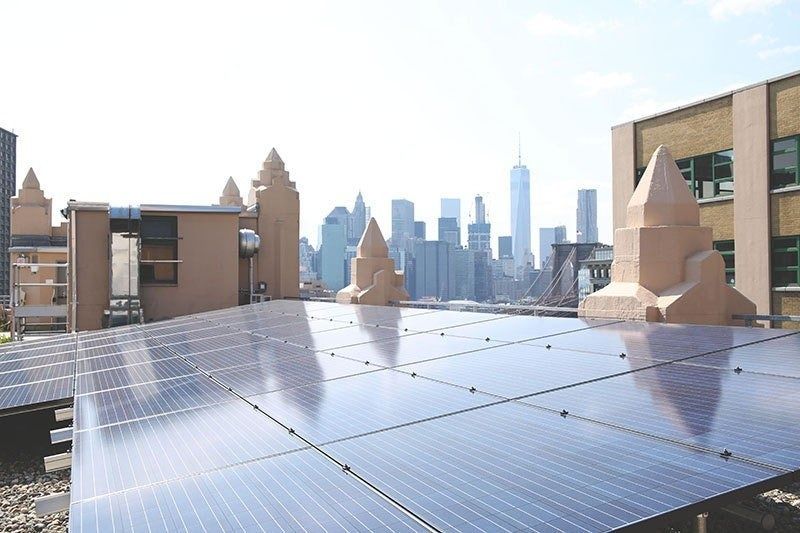Etsy: Solar panels on the roof with the Manhattan skyline behind