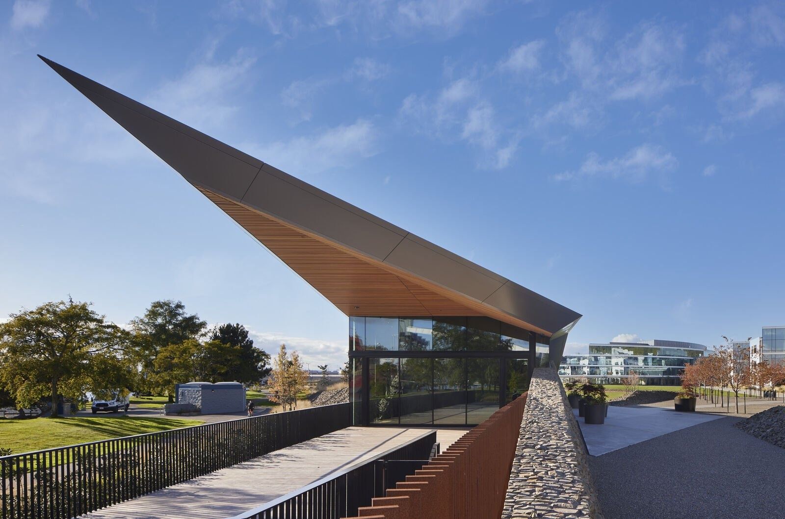 Expedia Group: Angular timber-roofed pavilion pointing toward the water