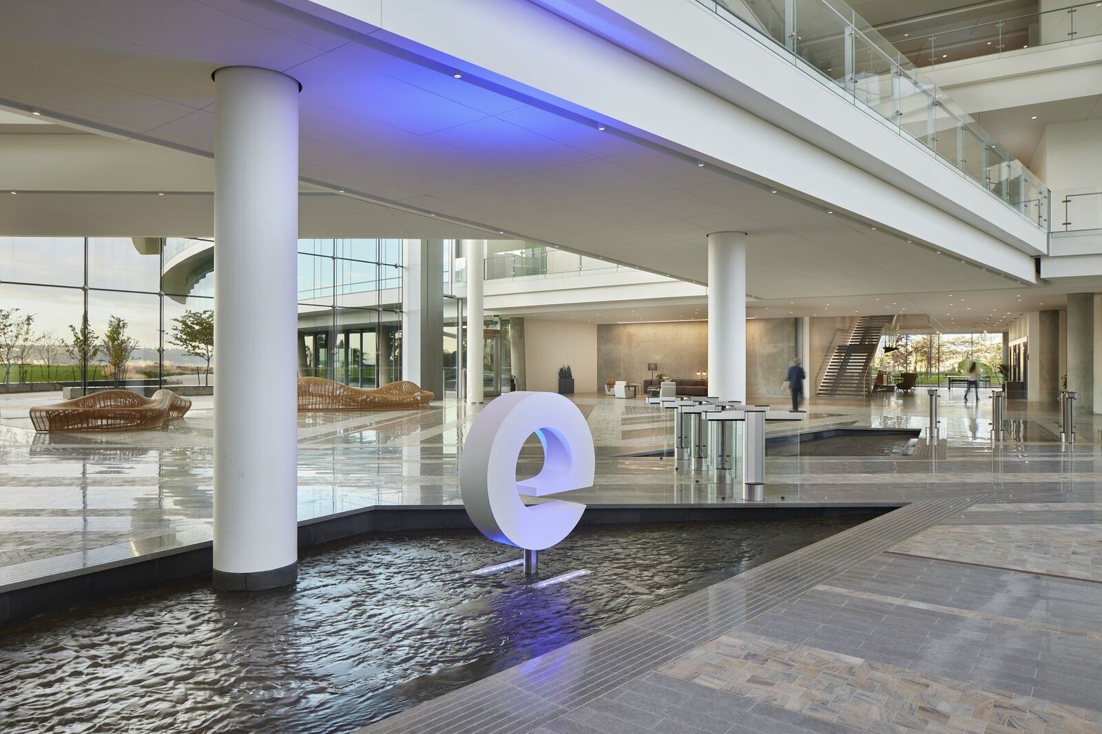 Expedia Group: Lobby with a large letter e sculpture in a reflecting pool