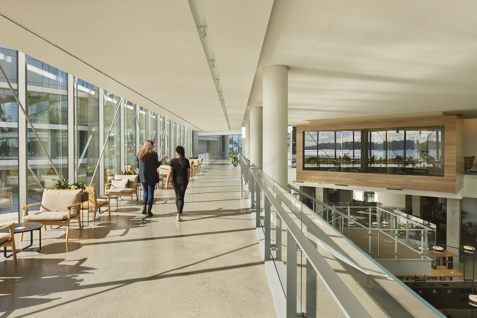 Expedia Group: Long glass gallery with seating and a view over the water