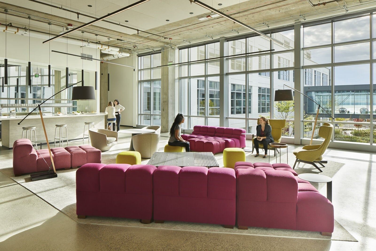 Expedia Group: Open lounge with red sofas and full-height windows