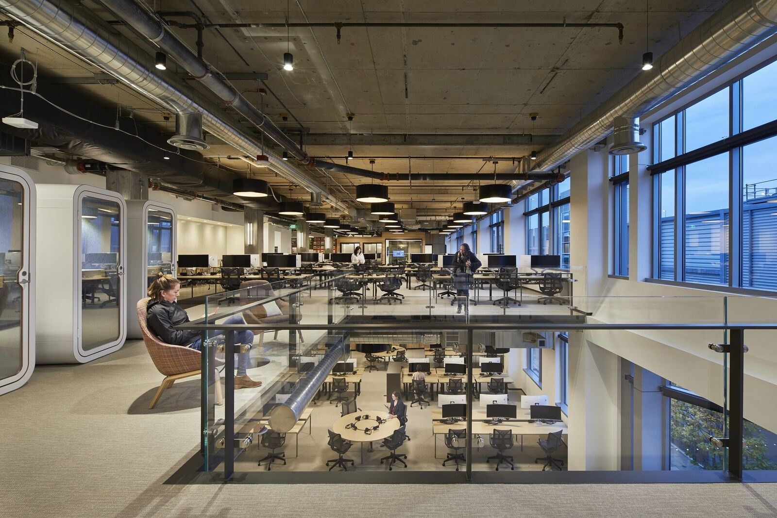 Expedia Group: Open office floor seen from a mezzanine above a café