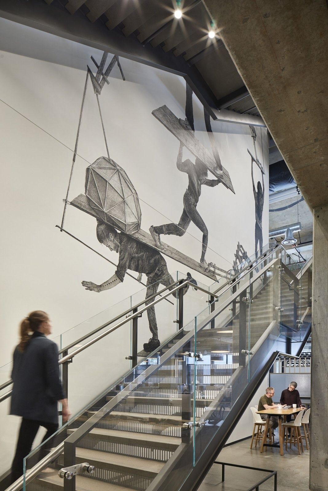 Expedia Group: Stair beside a graphic mural of a traveller