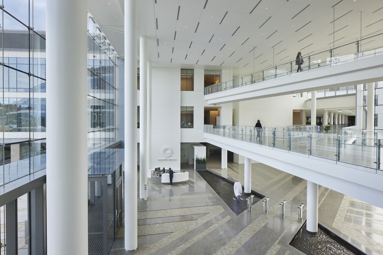 Expedia Group: Tall white atrium with bridges and balconies