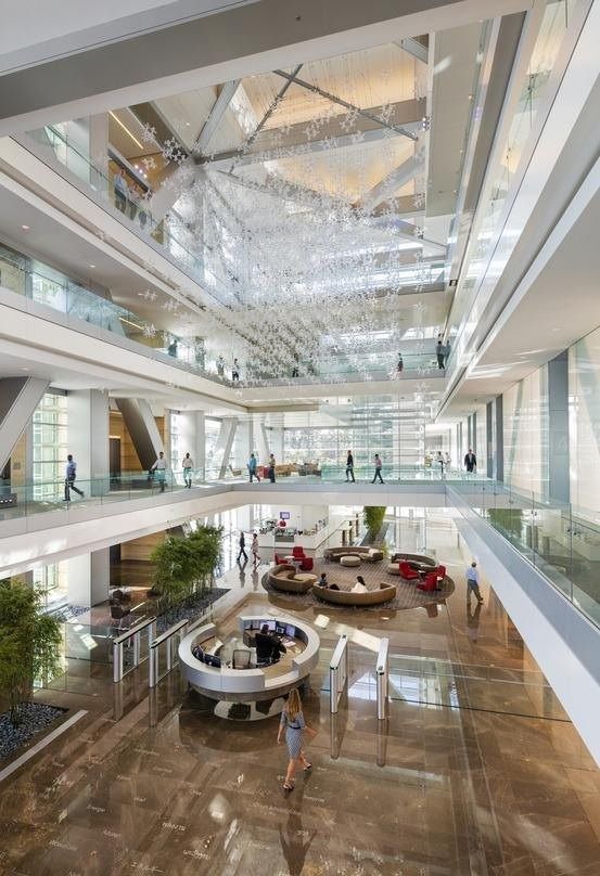 ExxonMobil: Atrium with a hanging artwork and lounge below