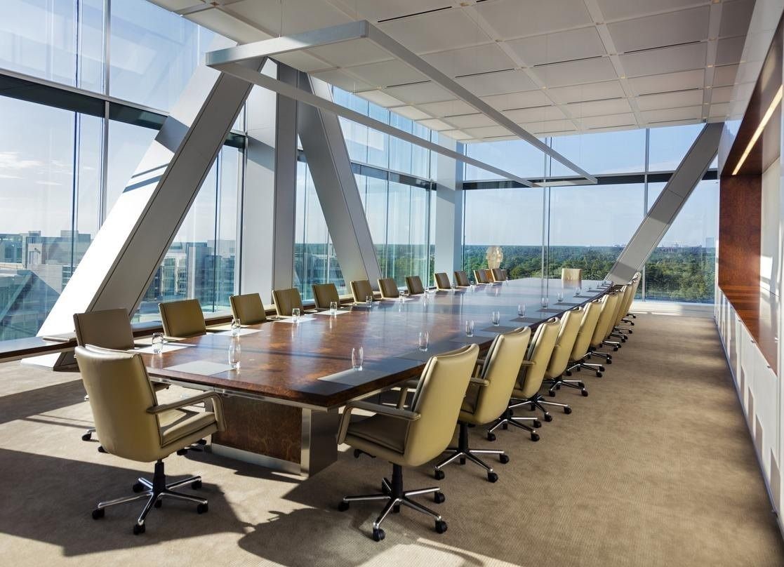 ExxonMobil: Boardroom with a long table under diagonal steel braces and tall windows