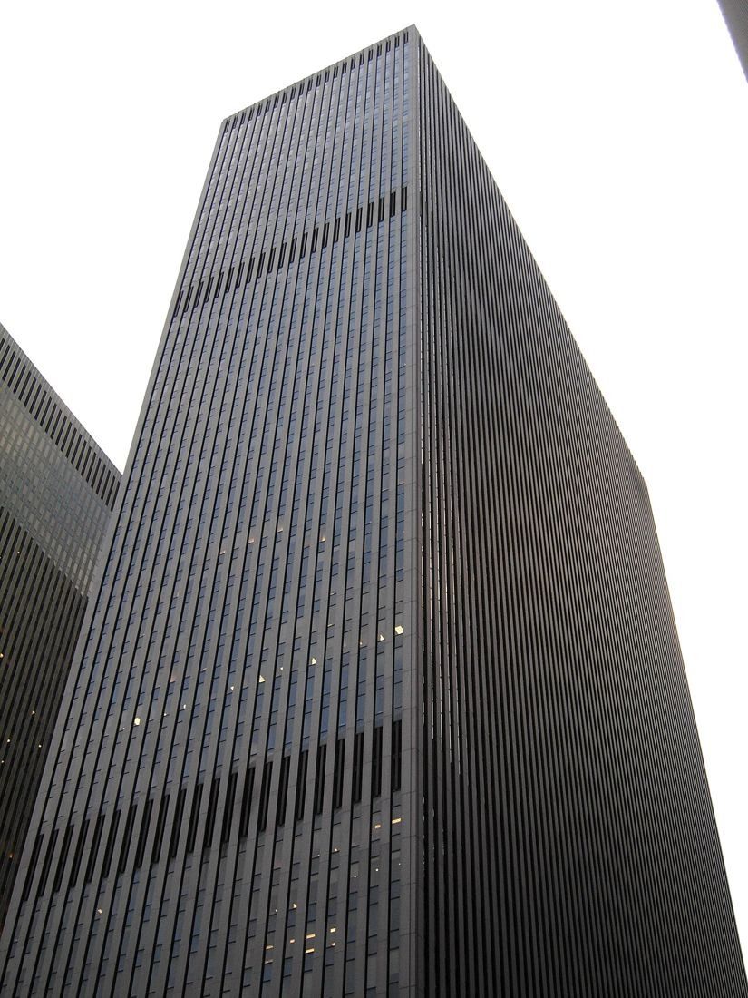 Dark vertical-striped skyscraper seen from below