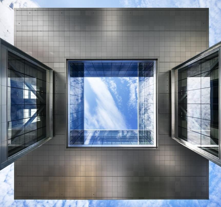 ExxonMobil: Square opening in a metal ceiling showing the sky