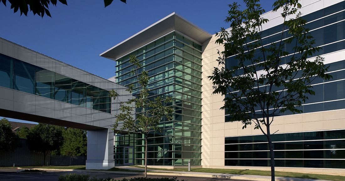 FedEx: Skyway meeting a glass stair tower between stone-clad office wings