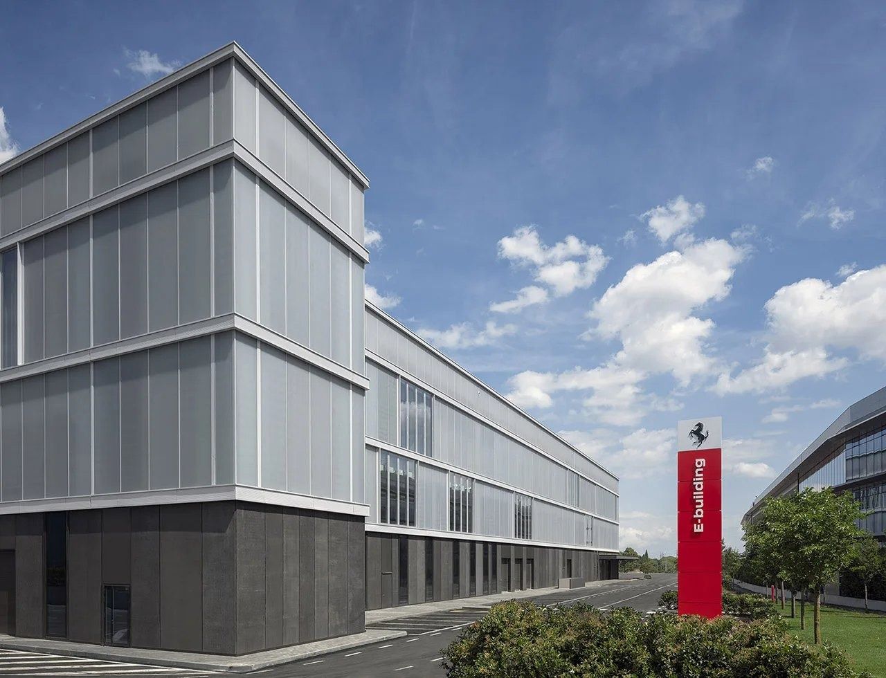 Ferrari: Building with the Ferrari sign on a red pylon