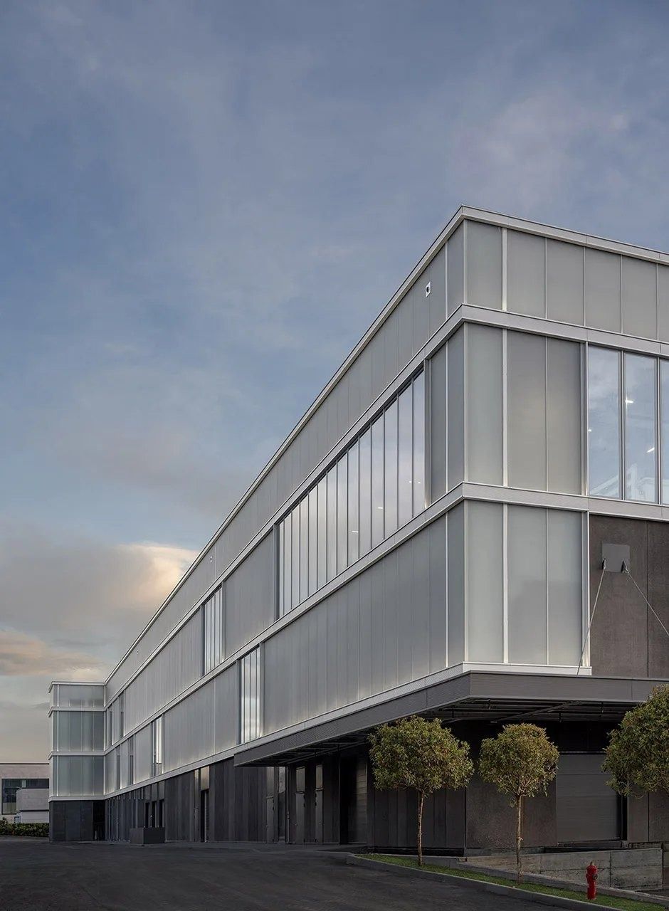 Ferrari: Glass façade under a cloudy sky
