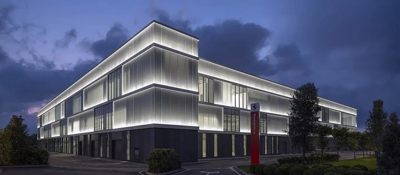 Ferrari: Low glass building lit at night