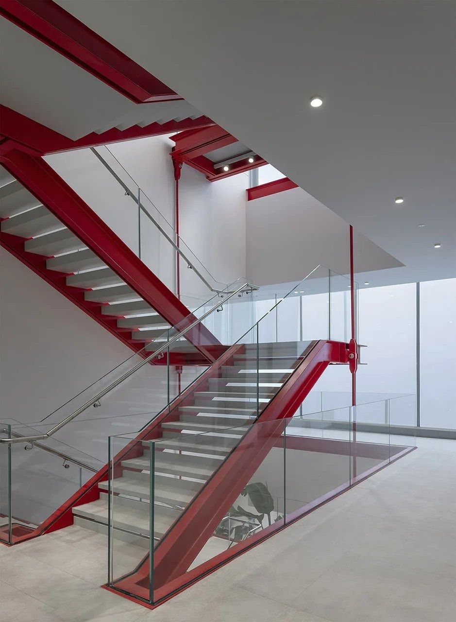 Ferrari: Red steel staircase in a white hall