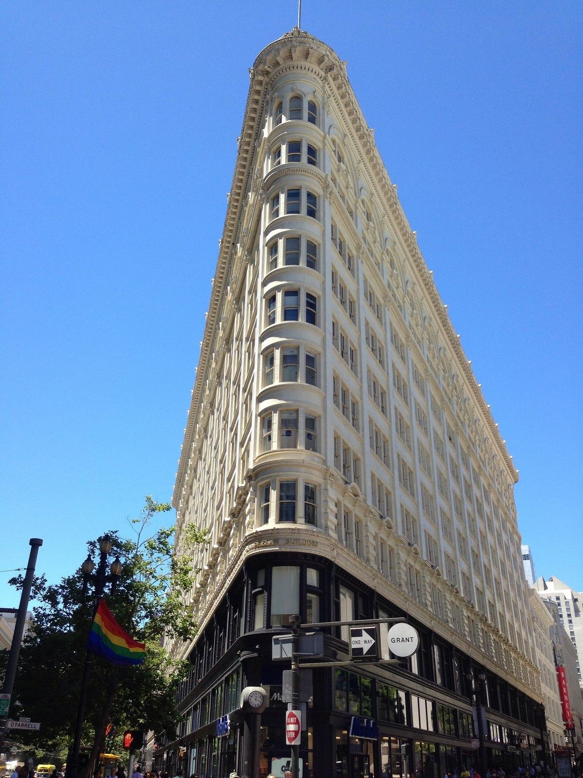 Figma: Cream flatiron-shaped building against a clear blue sky