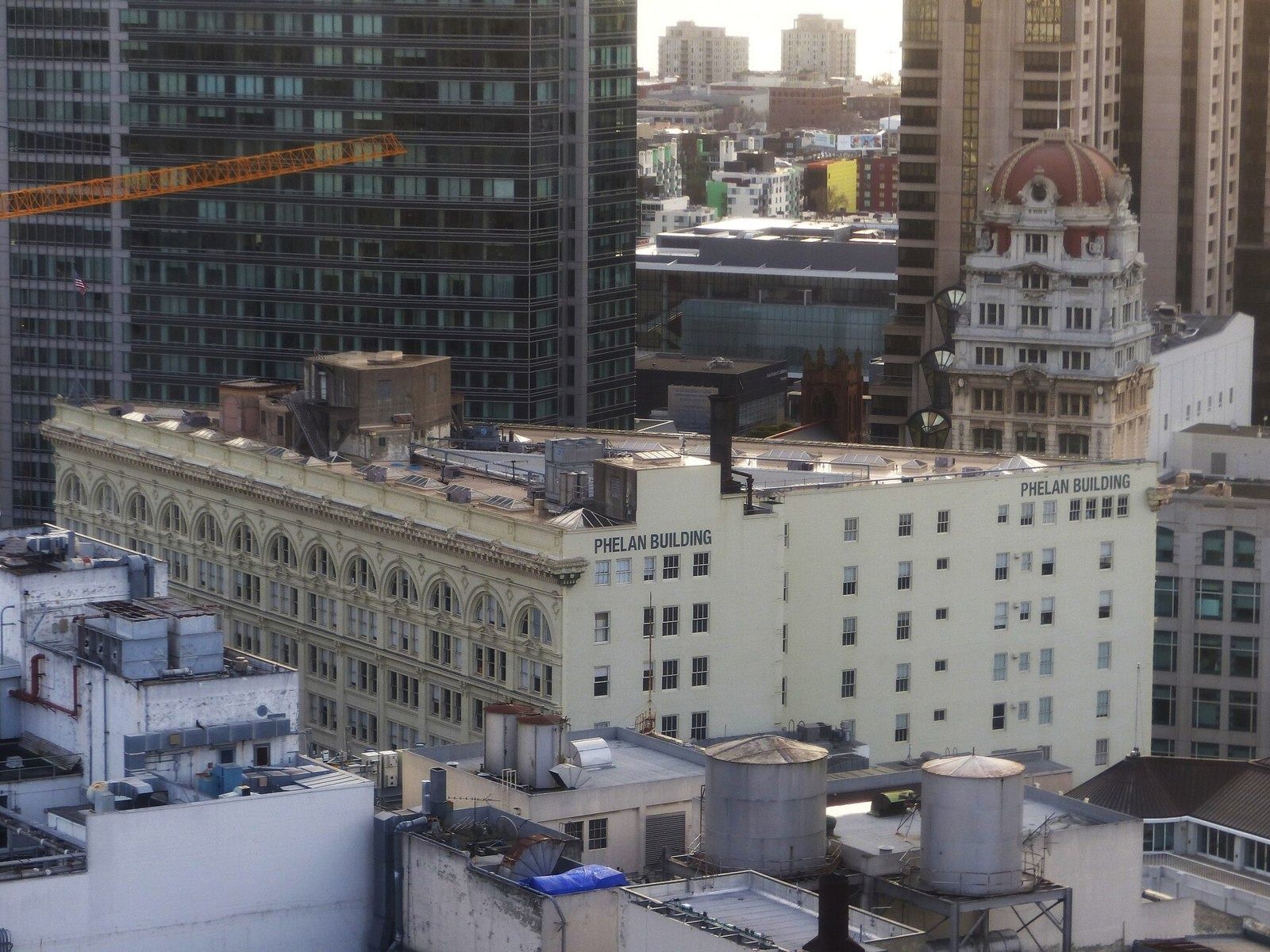Figma: Rooftop view of the long cream building with PHELAN BUILDING painted on its side wall