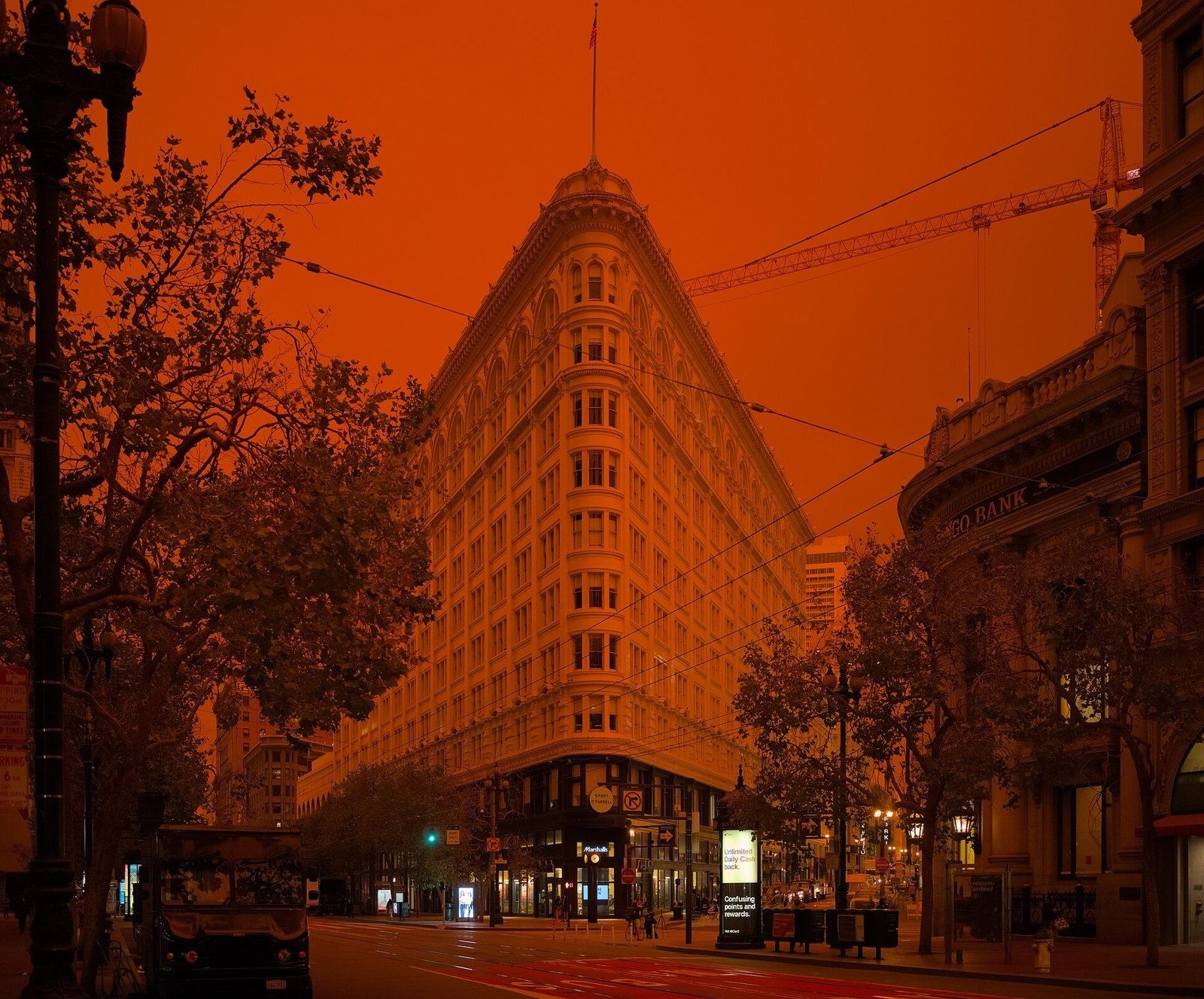 Figma: The flatiron building under an orange sky with street trees in front