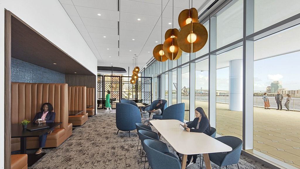 FIS: Booths and tables with copper pendant lamps beside a wall of windows