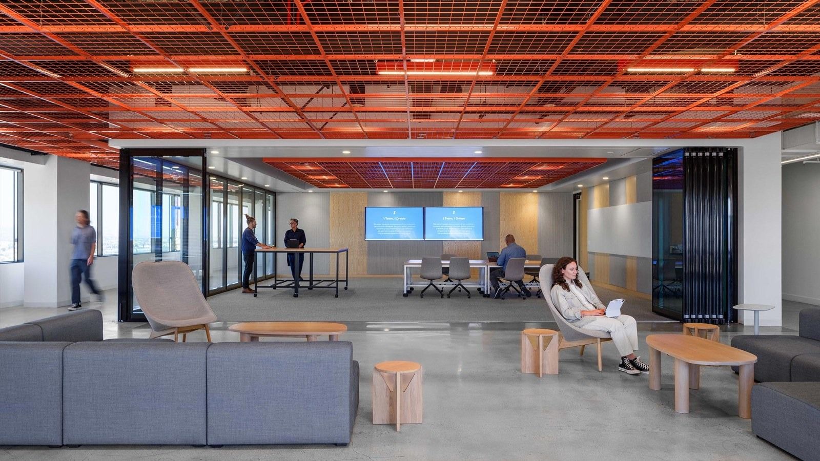 Fivetran: A large room with an orange grid ceiling, sofas and a screen