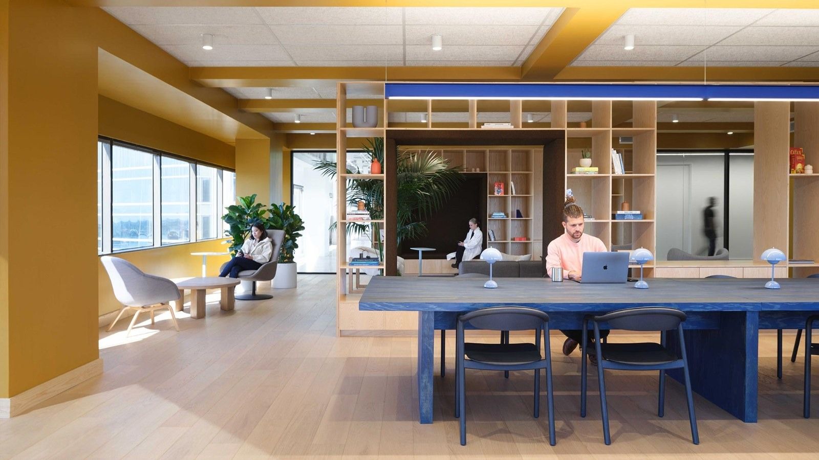 Fivetran: A long blue table under a yellow ceiling with wooden shelving