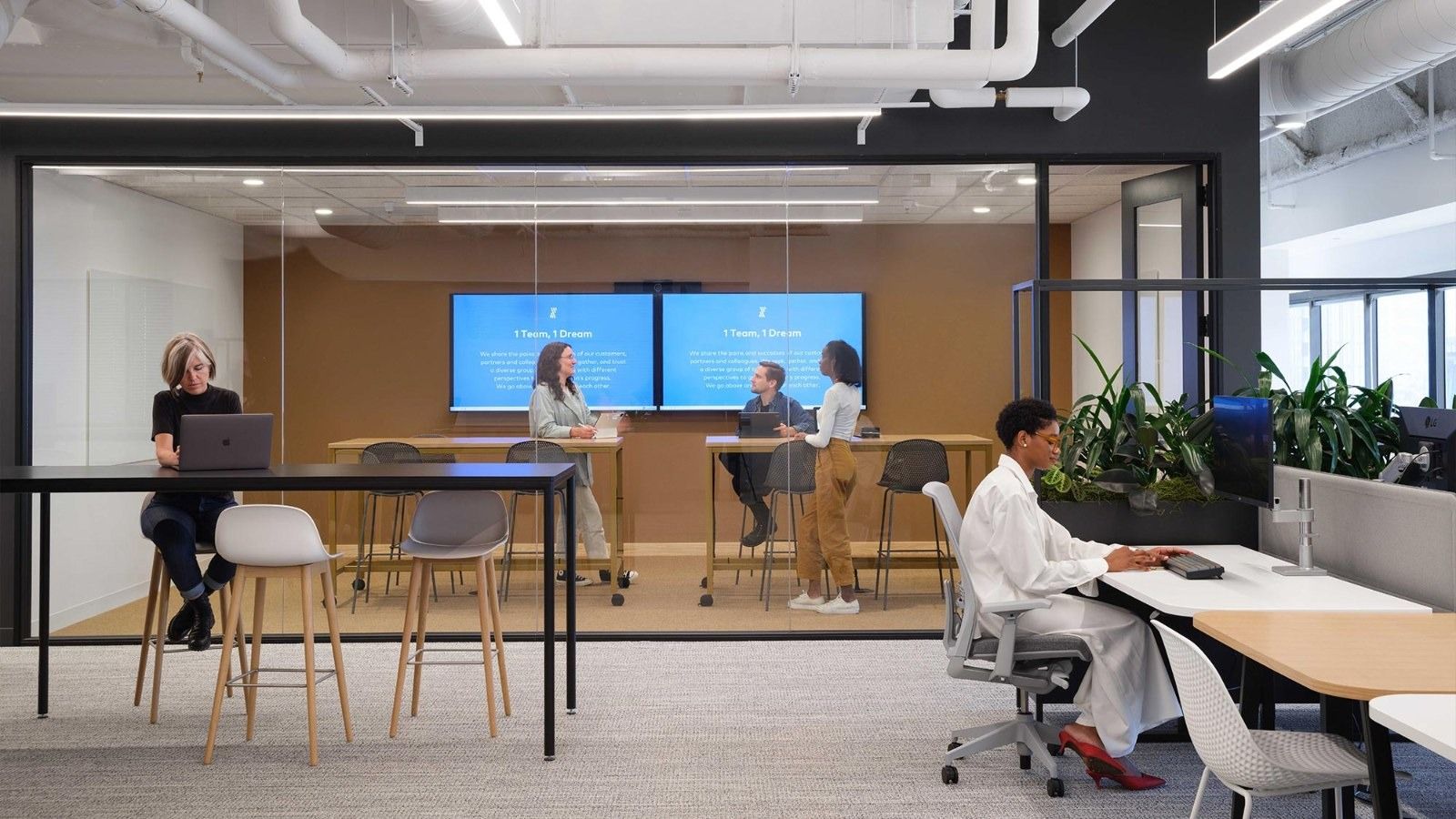 Fivetran: A meeting area with screens and high tables